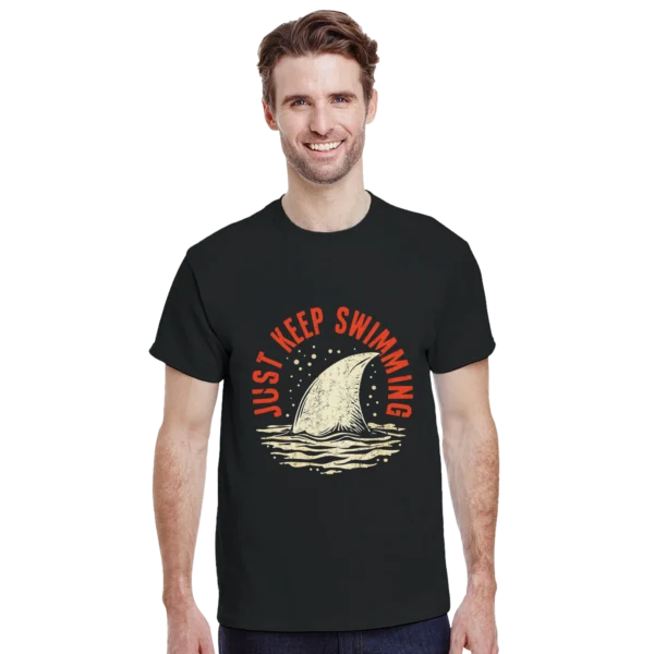 Keep Swimming Shark Fin Tee , Heavyweight Unisex Crewneck T-shirt in Dark Heather or Black